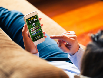 Lady lying on a lounge gambling on her phone