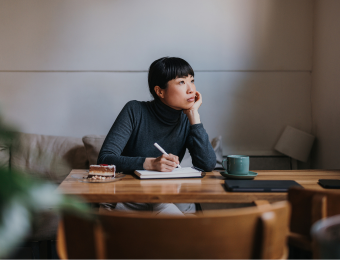 Women in coffee shop distracted and in deep thought
